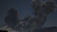 A plume of smoke billows during a US strike on Yemen's Huthi-held capital Sanaa early on March 16, 2025. Photo by Mohammed HUWAIS / AFP.