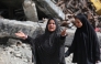 A woman gestures as Palestinians leave Beit Hanun in the northern Gaza Strip with their belongings, heading towards Gaza City following Israeli evacuation orders on March 19, 2025. (Photo by Bashar Taleb / AFP)