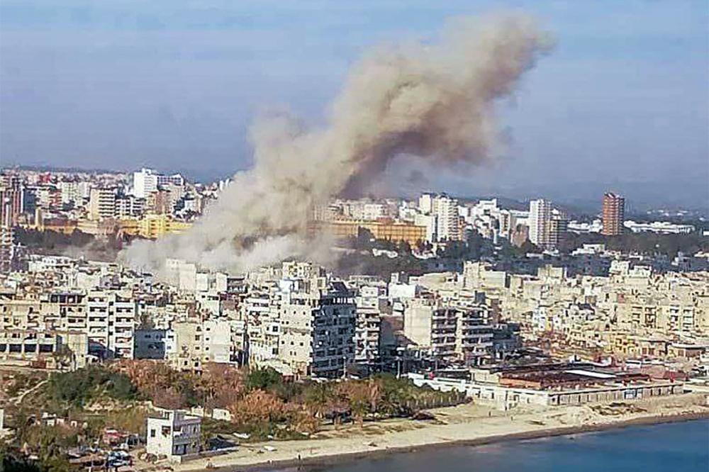 This handout picture released by the Syrian Arab News Agency (SANA) shows smoke billowing over the coastal city of Latakia after an explosion on March 15, 2025. (Photo by SANA / AFP) 