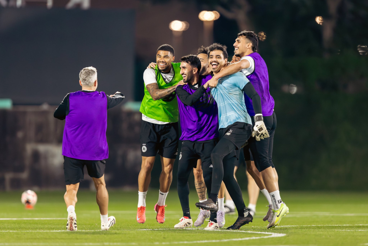 Al Sadd  players share a light moment during a training session on Sunday night.