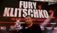 Wladimir Klitschko goes head to head with an image of Tyson Fury during the press conference. (Reuters / Peter Cziborra) 