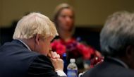 United Kingdom Foreign Secretary Boris Johnson (L) and European Union High Representative Federica Mogherini (rear) listen as United States Secretary of State John Kerry speaks during a meeting of foreign ministers from Germany, the UK, France, Italy and 