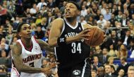 This file photo taken on January 16, 2014 shows Brooklyn Nets' player Paul Pierce (R) dribbling past the Atlanta Hawks' Louis Williams (L) during the NBA Global Games London 2014 basketball match between Atlanta Hawks and Brooklyn Nets at the O2 Arena in 