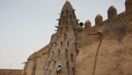 File photo of a UN peacekeeper from Burkina Faso guarding the Djinguereber mosque, built in the 14th century, during a visit by a UN delegation on election day in Timbuktu, Mali. Reuters/Joe Penney/Files