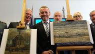 Axel Ruger (C), Director of the Van Gogh museum poses next to two recently recovered stolen paintings by late Dutch artist Vincent Van Gogh entitled 