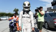 Mercedes AMG Petronas F1 Team's British driver Lewis Hamilton is driven back to the pit, after his car caught fire during the Formula One Malaysian Grand Prix in Sepang on October 2, 2016. (AFP / MANAN VATSYAYANA)