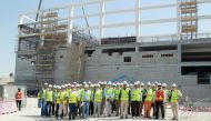 International Engineering Insurance Association delegates posing for a group picture at the construction site of the Khalifa International Stadium.