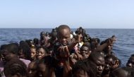 Migrants wait to be rescued by members of Proactiva Open Arms NGO in the Mediterranean Sea, some 12 nautical miles north of Libya, on October 4, 2016.AFP / ARIS MESSINIS
