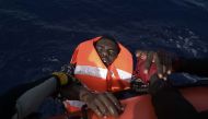 A migrant is rescued by members of Proactiva Open Arms NGO in the Mediterranean Sea, some 12 nautical miles north of Libya, on October 4, 2016. At least 1,800 migrants were rescued off the Libyan coast, the Italian coastguard announced, adding that simila