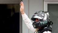 Mercedes AMG Petronas F1 Team's German driver Nico Rosberg waves after taking pole position in the qualifying session at the Formula One Japanese Grand Prix in Suzuka on October 8, 2016. / AFP / BEHROUZ MEHRI