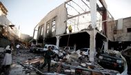 People stand at the site of an airstrike which witnesses said was by Saudi-led coalition aircraft on mourners at a hall in the Houthi-dominated Yemeni government, was being held, in Sanaa, Yemen October 8, 2016. Reuters/Khaled Abdullah