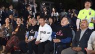  Fans of Japanese novelist Haruki Murakami react when the Swedish Academy awarded the Nobel prize for literature to US musician Bob Dylan at a shrine in Tokyo on October 13. 2016. US music legend Bob Dylan won the Nobel Literature Prize on October 13, the