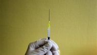 A nurse prepares a H1N1 flu vaccine shot at a hospital in Budapest, Hungary, November 20, 2009. (REUTERS / Karoly Arvai)