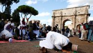 Muslims hold Friday prayers in front of the Colosseum in Rome, Italy October 21, 2016, to protest against the closure of unlicensed mosques. (REUTERS/Tony Gentile) 