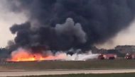 Still image taken from video shows fire trucks aiming their hoses at the burning wreckage of a small plane which crashed at the edge of the runway at the airport in Valletta, Malta, 24 October 2016. (REUTERS/Ed De Gaetano via Reuters)