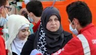 Women disembark from the Siem Pilot on October 24, 2016 in Palermo after rescue operations of migrants at see during the week-end. During a dramatic 24 hours, the crew of the Norwegian Siem Pilot, a vessel built as an oil platform supply ship but now used