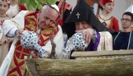 Pope Francis and Catholicos of All Armenians Karekin II water a tree planted in a Noahs Ark sculpture during an ecumenical meeting and a prayer for peace in Republic Square, Yerevan on June 25, 2016. (AFP / TIZIAN) 