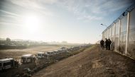 Police officers wait at the Calais 'jungle' camp during the fourth day of evacuation in Calais, France on October 27, 2016.   NnoMan - Anadolu Agency 