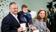 Moldova's Socialist Party presidential candidate Igor Dodon, accompanied by his wife Galina and son Nikolai, casts his vote at a polling station during a presidential election in Chisinau, Moldova, October 30, 2016. REUTERS/Gleb Garanich