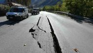 A picture shows cracks on the road outside the center of Norcia after a 6.6 magnitude earthquake on October 30, 2016.  AFP / ALBERTO PIZZOLI
