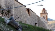 A bell is seen on the ground near a church following an earthquake in Norcia, Italy, October 30, 2016. (REUTERS/Remo Casilli)