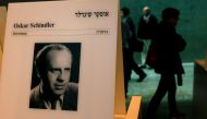  This file photo taken on March 04, 2015 shows visitors walking past a portrait of the German industrialist who saved more than a thousand Jews, Oskar Schindler at the Yad Vashem Holocaust memorial museum in Jerusalem. A former factory of Oskar Schindler 