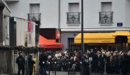 French police stand guard as people gather in front of the Le Petit Cambodge restaurant at the Rue Alibert in Paris, on November 13, 2016, ahead of a ceremony to mark the first anniversary of the Paris terror attacks. AFP / PHILIPPE LOPEZ