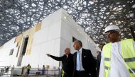 This file photo taken on January 18, 2016 shows French Foreign Minister Laurent Fabius (C) and French architect Jean Nouvel (L) visiting the construction site of the future Louvre museum on Saadiyat island, outside the UAE capital Abu Dhabi on January 18,