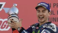 Movistar Yamaha MotoGP's Spanish rider Jorge Lorenzo celebrates winning on the podium after the MotoGP race of the Motul Comunidad Valenciana Grand Prix at the Ricardo Tormo racetrack in Cheste, on November 13, 2016. / AFP / JAVIER SORIANO
