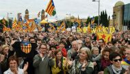 Former President of the Catalan Government Artur Mas (C-L) and Catalan Parliament President Carme Forcadell (C) applaud during a demonstration organized by ANC (Catalan National Assembly), AMI (Association of Municipalities for Independence) and Omnium Cu