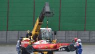 The car of Scuderia Ferrari's Finnish driver Kimi Raikkonen is removed from the track after he crashed and the race was stopped during the Brazilian Grand Prix at the Interlagos circuit in Sao Paulo, Brazil, on November 13, 2016. / AFP / Miguel SCHINCARIO