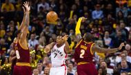 Kyle Lowry #7 of the Toronto Raptors passes between Channing Frye #8 and Kyrie Irving #2 of the Cleveland Cavaliers during the second half at Quicken Loans Arena on November 15, 2016 in Cleveland, Ohio. Jason Miller/Getty Images/AFP