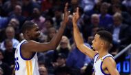 Kevin Durant #35 and Steph Curry #30 of the Golden State Warriors high five during the first half of an NBA game against the Toronto Raptors at Air Canada Centre on November 16, 2016 in Toronto, Canada. Vaughn Ridley/Getty Images/AFP