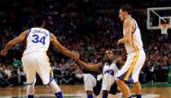 Golden State Warriors guard Shaun Livingston (34) and Golden State Warriors guard Klay Thompson (11) help up Golden State Warriors forward Kevin Durant (35) during the first half against the Boston Celtics at TD Garden./Winslow Townson
