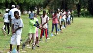 (FILES) This file photo taken on October 22, 2016 shows children playing golf on October 22, 2016 at the golf course in Yamoussoukro, during an introduction day for children aiming to promote this sport in Ivory Coast. AFP / SIA KAMBOU