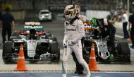 Mercedes AMG Petronas F1 Team's British driver Lewis Hamilton leaves his car after taking pole position in the qualifying session as part of the Abu Dhabi Formula One Grand Prix at the Yas Marina circuit on November 26, 2016. (AFP / MOHAMMED AL-SHAIKH)