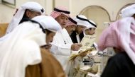 A Kuwaiti judge (C) and his aides count the ballots at a polling station at the end of the vote in the Sabah al-Salem district on the outskirts of Kuwait city on November 26, 2016. AFP / Yasser Al-Zayyat
