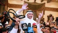 Kuwaiti candidate and former parliament speaker Marzouq al-Ghanem (C), celebrates with his supporters following the announcment of his victory in the parliamentary election, in Kuwait city, early November 27, 2016.  AFP / Yasser Al-Zayyat
