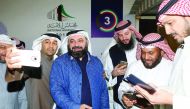 Kuwaiti Islamist candidate and opposition leader Waleed Al Tabtabaee (centre) celebrates with his supporters following the announcment of his victory in the parliamentary election, in Kuwait city, yesterday.