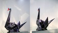 This handout combination photo taken on September 16, 2014 and released on November 29, 2016 by Guo Jian shows a black swan sculpture by Chinese artist Guo Jian in Beijing. AFP PHOTO / Guo Jian