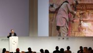 Director of the Arab Regional Centre for World Heritage, Mounir Bouchenaki speaks in front of a giant screen during the opening ceremony of a conference gathering officials and experts from around the world gather to discuss forming a global alliance to p