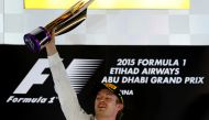 Nico Rosberg celebrating on the podium at the Yas Marina circuit in Abu Dhabi after the Abu Dhabi Formula One Grand Prix. (AFP / MARWAN NAAMANI)