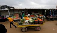 A Syrian refugee transports a vegetable cart during rainy weather at the Al Zaatari refugee camp in the Jordanian city of Mafraq, near the border with Syria December 18, 2016. REUTERS/Muhammad Hamed