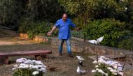 Scottish historian and writer William Dalrymple walks amongst his pigeons at his farm house in New Delhi. Many precious stones have a blood-soaked history, but a new book reveals the world's most famous diamond the Kohinoor surpasses them all, with a lita