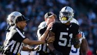 Referees hold back Oakland Raiders outside linebacker Bruce Irvin (51) after a play against the Indianapolis Colts during the second quarter at the Oakland Coliseum. Kelley L Cox