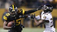 Pittsburgh Steelers wide receiver Demarcus Ayers (15) stiff arms Baltimore Ravens cornerback Tavon Young (36) during the fourth quarter at Heinz Field. The Steelers won 31-27. Charles LeClaire