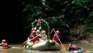 Novanto Rahman and his bride Sandra Fidelia Novianti, a volunteer who takes part in a Ciliwung river clean-up initiative, hold part of their wedding ceremony on the Ciliwung, which runs more than 100 km (60 miles) from its source in West Java to Jakarta b