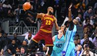 Cleveland Cavaliers' forward LeBron James passes the ball as he is defended by Charlotte Hornets' forward Michael Kidd-Gilchrist and forward centre Cody Zeller during their NBA game at the Spectrum Center on Saturday. Cavaliers won 121-109.