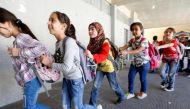 Syrian refugee children queue as they head towards their classroom at a school in Mount Lebanon, October 7, 2016. REUTERS/Mohamed Azakir