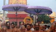 In this photograph taken on November 8, 2016, India temple priests carry a diety of Hindu god Parthasarathy in a procession on a street in Chennai. AFP / Arun SANKAR
